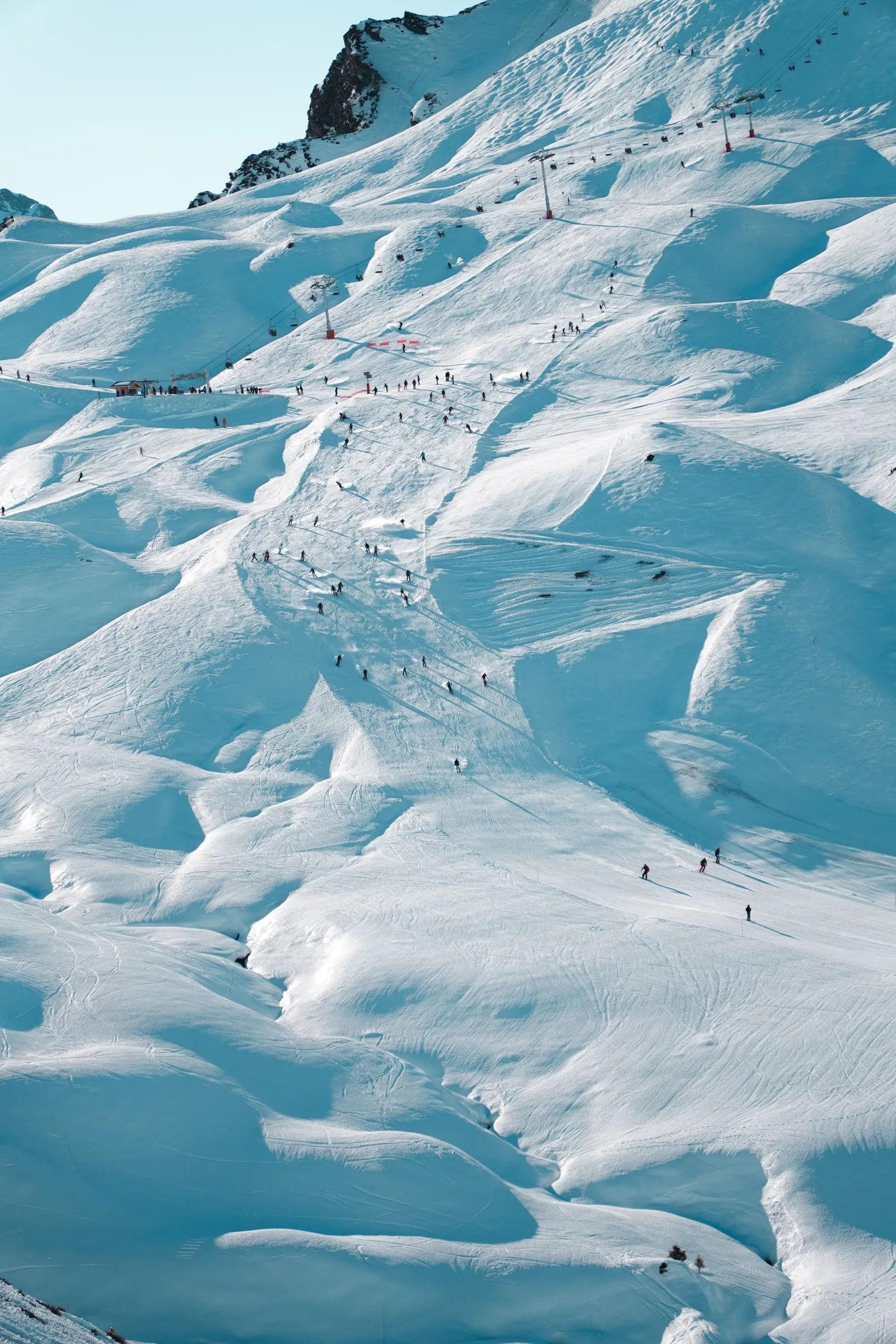 A piste in the Portes du Soleil dotted with skiers from above.